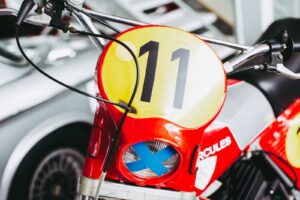 red and yellow motorcycle with black and white arrow sign